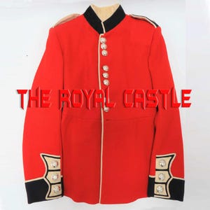 May include: A bright red military-style jacket featuring a black high collar, black cuffs with decorative silver buttons, and a vertical row of silver buttons down the front. The text THE ROYAL CASTLE is superimposed across the center of the jacket.