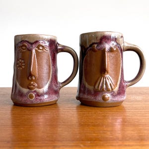 David Stewart Lions Valley Woman and Man California Pottery Mugs Red Beige 3 3/4" // Condition: Crazing throughout the glaze
