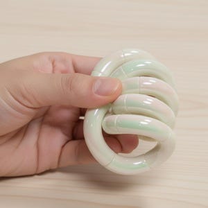 May include: A set of three ceramic mugs with a speckled, matte finish in cream, light grey, and dark grey. Each mug has a simple, minimalist design, ideal for coffee or tea.