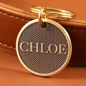 May include: A white ceramic mug with a black handle and the text "But First, Coffee" in a black, bold font. The mug is on a white surface. The mug is approximately 4 inches tall.