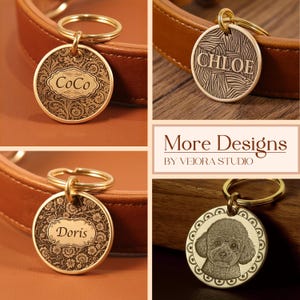May include: Four circular gold-toned metal pet tags with split rings. Three tags feature engraved names CoCo, CHLOE, and Doris with intricate floral or abstract patterns. One tag displays a portrait of a poodle. Text reads More Designs BY VEIORA STUDIO.