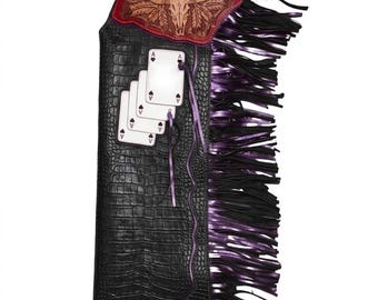 Rodeo chaps met juk in de vorm van een stierenschedel en ingelegde aaskaarten | Zwarte leren chaps met krokodillenprint en metallic paarse franjes