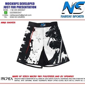 May include: MMA shorts with a black and white design. The shorts feature a black waistband and a white front panel with black splatter and a graphic. The text "NABTAY SPORTS" is visible.