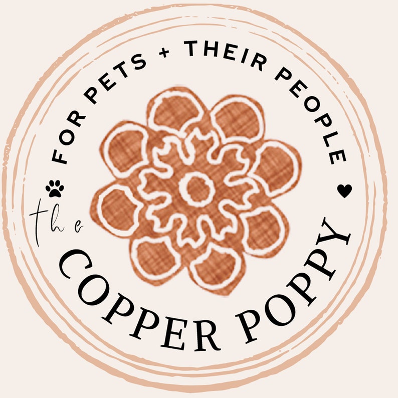 May include: A brown and white floral design with the text "the COPPER POPPY" and "FOR PETS + THEIR PEOPLE" in a circle.