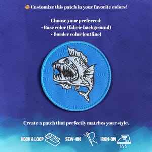 May include: A circular embroidered patch featuring a white fish with sharp teeth on a light blue fabric background with a matching blue border. Text includes: Customize this patch in your favourite colours! Choose your preferred: Base colour (fabric background) Border colour (outline) Create a patch that perfectly matches your style. Hook & loop, sew-on, iron-on.