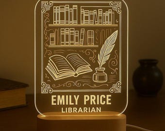May include: A clear acrylic LED lamp with a bookshelf design, an open book, and a quill and inkwell. The lamp has a wooden base and features the name "EMILY PRICE" and the title "LIBRARIAN".