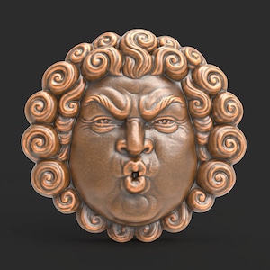 May include: A bronze-colored, circular wall sculpture featuring a stylized face with a stern expression. The face has a prominent nose, pursed lips, and curly hair around the perimeter. The sculpture is set against a dark background.