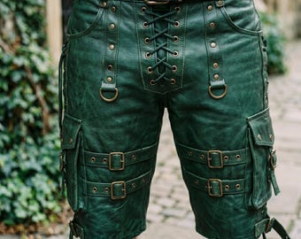May include: Green leather shorts with multiple pockets, buckles, and a laced front. The shorts have a matching belt with a large buckle. The shorts are detailed with metal rivets and D-rings.
