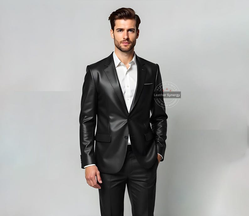 May include: A black leather suit, featuring a tailored jacket with a notched lapel and matching trousers. The suit is paired with a white dress shirt. The image is set against a neutral background.