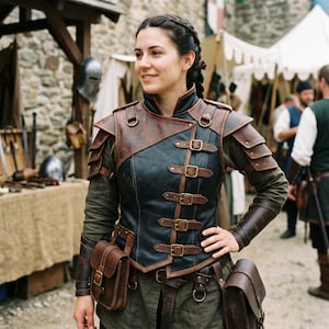 May include: A brown and black leather vest with multiple buckles and shoulder armor. The vest is worn over a green long-sleeved shirt. Two brown leather pouches are attached to the waist. The background shows a medieval market setting.