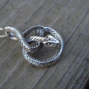 Coiled snake necklace is sterling silver