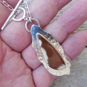 Sterling silver pendant with a petrified wood stone