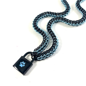 May include: A black and blue chain necklace with a black padlock pendant featuring a blue paw print.