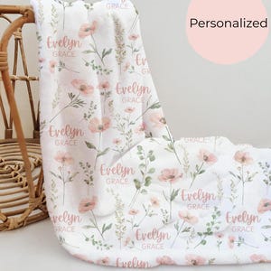 Personalized wildflower blanket for girl baby shower gift, a soft and sentimental swaddle perfect for welcoming a newborn into a cozy wildflower nursery.