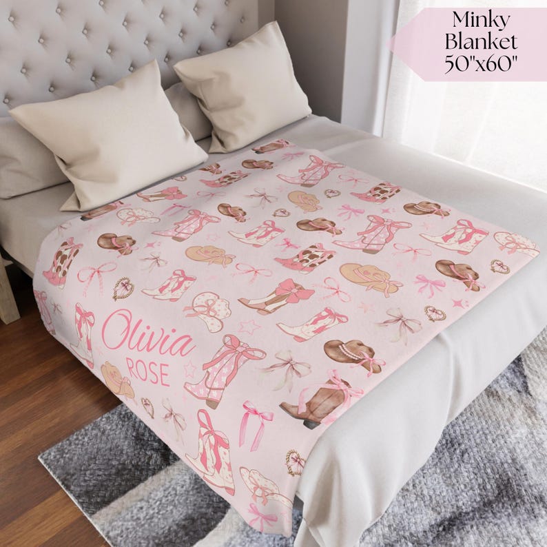 Vintage western wagon wheel and saddle baby blanket with hand-stitched details, ideal for rustic cowgirl nursery décor, western-themed baby shower gift, or heirloom keepsake.