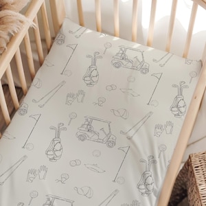 Personalized golf crib sheet and sport theme nursery bedding for baby boy's first nursery.