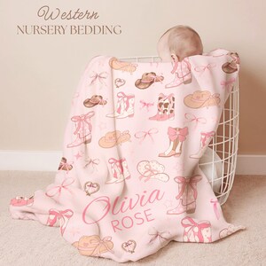 Personalized rodeo-inspired toddler blanket with lassos, stars, and pink accents, perfect for western kids’ room décor, rustic country styling, and unique cowgirl birthday gift.