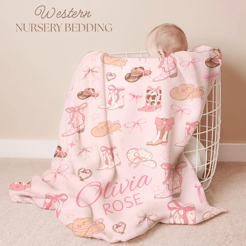 Personalized rodeo-inspired toddler blanket with lassos, stars, and pink accents, perfect for western kids’ room décor, rustic country styling, and unique cowgirl birthday gift.