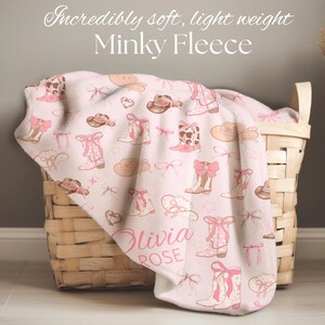 Rustic cowgirl crib quilt with personalized name stitching, designed for a western baby shower gift, country-inspired nursery decoration, and keepsake for a little cowgirl’s room.