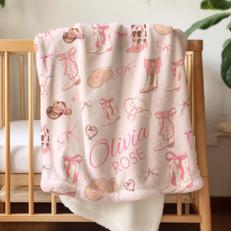 Personalized cowgirl baby blanket in soft pink and brown with custom name embroidery, perfect for western nursery décor, rustic cowgirl baby shower gift, or western girl bedroom accessory.
