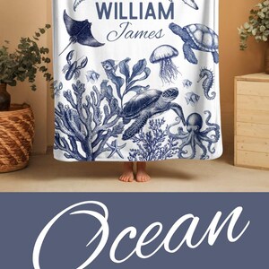 Ocean-Themed Newborn Blanket with Toile Turtle Print – Soft baby gift blanket designed for coastal nurseries, featuring nautical sea turtles and ocean waves.