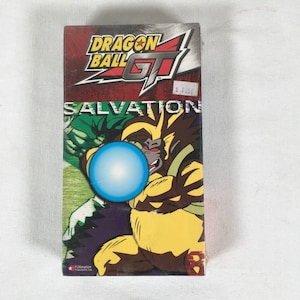 May include: A Dragon Ball GT "Salvation" VHS tape. The packaging features a large illustration of a yellow and brown character holding a blue energy ball. The Dragon Ball GT logo is at the top, with a price tag.