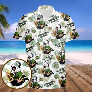 May include: White button-up shirt with a tropical print featuring a green and black illustration of a hooded figure with the text "Dungeon Daddy" repeated throughout.