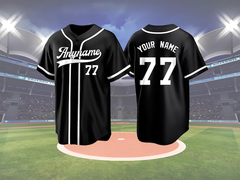May include: Black baseball jersey with white accents, featuring the text "Anyname" and the number 77 on the front. The back of the jersey displays "YOUR NAME" and the number 77. The jersey has a button-up front and is set against a baseball field backdrop.