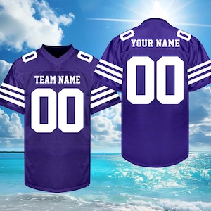 May include: Two purple football jerseys with white accents. One jersey displays "TEAM NAME" and the number "00", the other displays "YOUR NAME" and the number "00". The jerseys have white stripes on the sleeves.