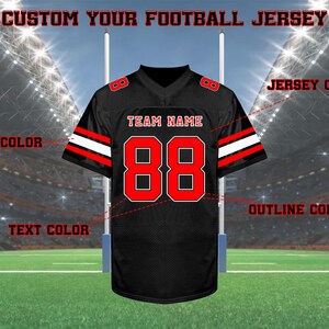 May include: Black football jersey with red and white accents. The jersey features the number 88 in red with a white outline, and the text "TEAM NAME" in white. The jersey is displayed on a football field.