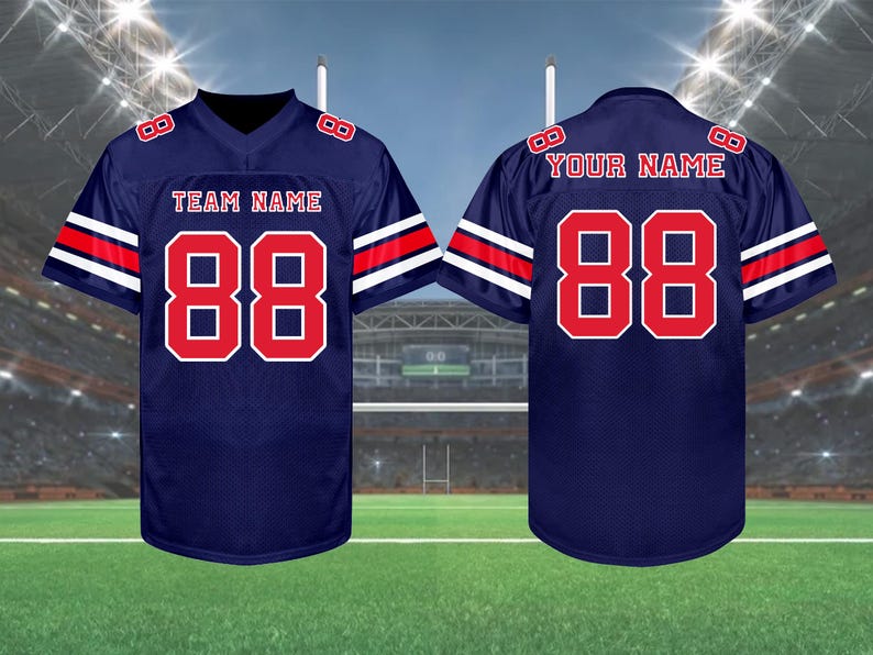 May include: Navy blue football jersey with red and white accents. The jersey features the number 88 in red on the front and back, with the text "TEAM NAME" and "YOUR NAME" above the numbers. The sleeves have red and white stripes.
