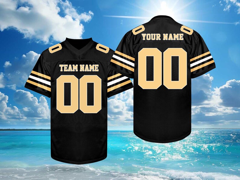 May include: Black football jersey with gold accents, featuring the number "00" on the front and back. The front displays "TEAM NAME", and the back says "YOUR NAME". The jersey has gold stripes on the sleeves.