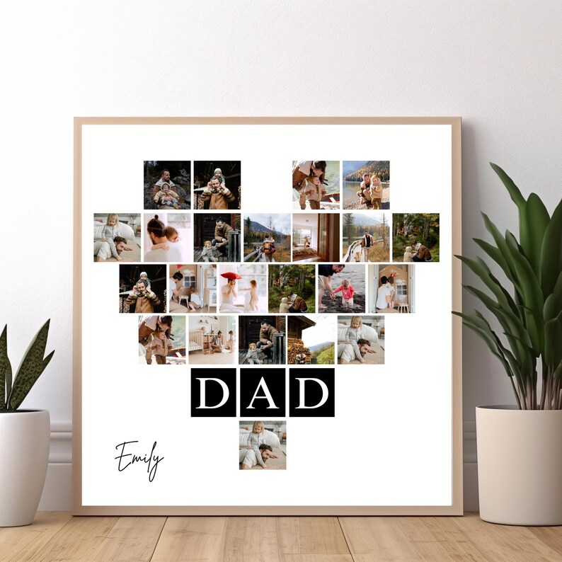 May include: A framed photo collage in a heart shape, filled with family photos. The word "DAD" is displayed in bold black letters, with the name "Emily" in cursive below. The frame is a light wood color.