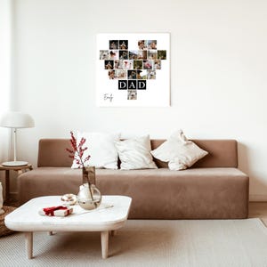 May include: A framed heart-shaped photo collage with multiple small images. The word "DAD" is spelled out in black block letters below the collage. The name "Emily" is written in cursive below the word "DAD".