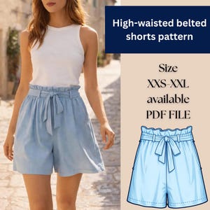 May include: A woman in a white vest top and light blue high-waisted belted shorts. The shorts feature a paper bag waist and a fabric tie. The image includes text: "High-waisted belted shorts pattern" and "Size XXS-XXL available PDF FILE."
