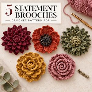 May include: Five crocheted flower brooches in burgundy, orange, olive green, mustard yellow, and dusty pink. The image includes a 5.0 mm crochet hook, a metal pin back, and text that reads 5 STATEMENT BROOCHES CROCHET PATTERN PDF.