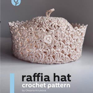 May include: A light beige raffia hat with a crocheted design. The hat has a rounded crown and a slightly flared brim. The text "raffia hat crochet pattern" is displayed in white and black font.