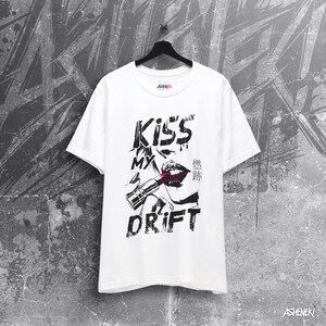 May include: White t-shirt with a black and white graphic print of a woman's lips with lipstick and the text "Kiss My Drift".
