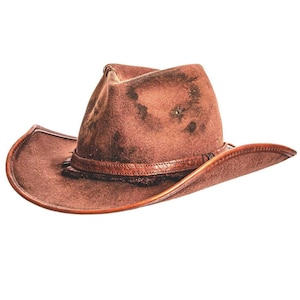 May include: A brown leather cowboy hat with a distressed, weathered texture. The hat features a pinched crown and a wide, curved brim. A matching leather band wraps around the base of the crown, adding a structured detail to the overall design.