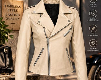 May include: A beige leather motorcycle jacket featuring a notched lapel, an asymmetrical front zipper closure, long sleeves, and multiple silver-toned zippered pockets. The jacket has a black interior lining and metallic snap button accents on the collar.