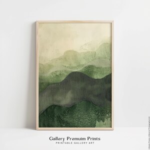 May include: A vertical rectangular wall art print in a light wood frame featuring an abstract landscape of layered rolling hills in varying shades of green, ranging from pale sage to deep forest green, with textured dot patterns on the slopes.