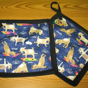 May include: Two blue and black pot holders with a pattern of goats doing yoga poses. The goats are brown and white and have words like "breathe", "energy", and "peace" written on their mats.