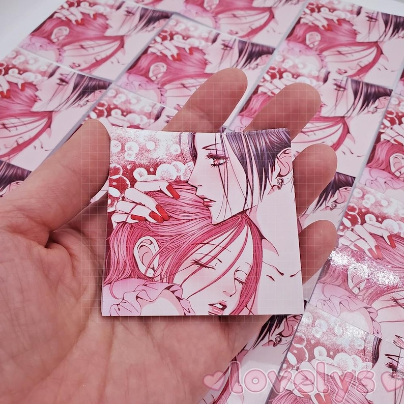 May include: A close-up of a pink and white anime illustration of two characters. The character on the left has long pink hair and is wearing a white dress. The character on the right has long black hair and is wearing a black dress. The characters are embracing each other.