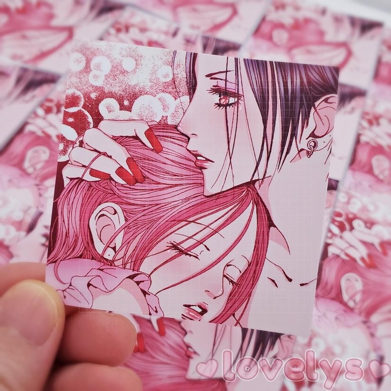 May include: A pink and white anime illustration of two women, one with long black hair and the other with long pink hair. The woman with black hair is holding the other woman's head in her hands. The background is a light pink with white dots.