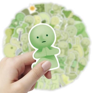 Peut inclure: Une feuille d'autocollants verts et blancs repr&eacute;sentant une vari&eacute;t&eacute; de personnages de dessins anim&eacute;s mignons. Les personnages sont tous dans des poses et des expressions diff&eacute;rentes, et certains tiennent des objets comme des fleurs ou des c&oelig;urs. Les autocollants sont parfaits pour ajouter une touche de fantaisie &agrave; votre agenda, votre ordinateur portable ou votre bouteille d'eau.