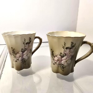 A pair of Vintage Nippon hand-painted porcelain cups