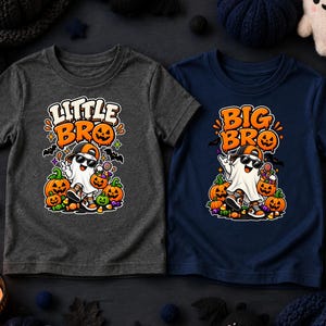 May include: A charcoal gray t-shirt and a navy blue t-shirt, each featuring a graphic of a ghost wearing a baseball cap and sunglasses, surrounded by pumpkins and candy. The gray shirt has the text LITTLE BRO, and the navy shirt has BIG BRO.