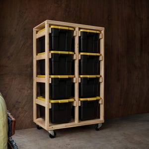 May include: A wooden storage shelf with wheels, featuring six black storage bins with yellow lids. The shelf is made of natural wood and has a simple design.