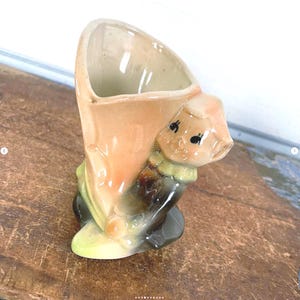 May include: A set of three ceramic mugs with a speckled, matte finish. Each mug features a different color: light blue, cream, and gray. The mugs have a simple, modern design with a rounded shape and a comfortable handle.