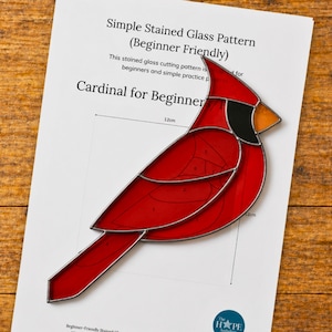 May include: A red stained glass cardinal bird pattern for beginners, with black and orange accents. The pattern is on a white sheet of paper, with the text "Cardinal for Beginner" and "Simple Stained Glass Pattern (Beginner Friendly)". The bird measures approximately 12cm.